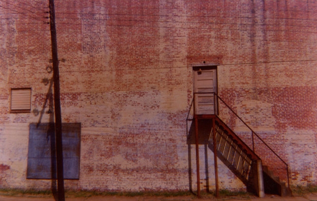 Wall of Abandoned Movie Theater (Distant View, Marion, Alabama), 1976, Extacolor Brownie print
